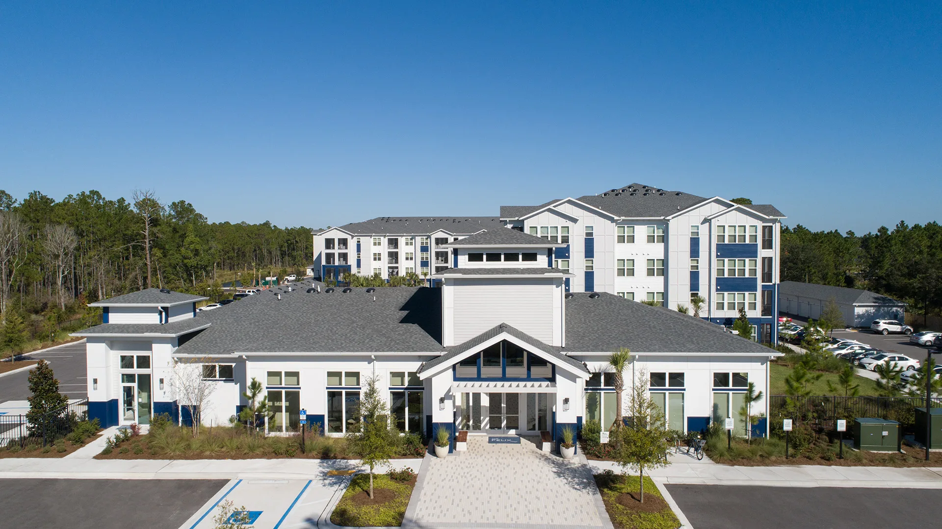 Aerial view of The FELIX clubhouse and four-story apartment buildings in Jacksonville